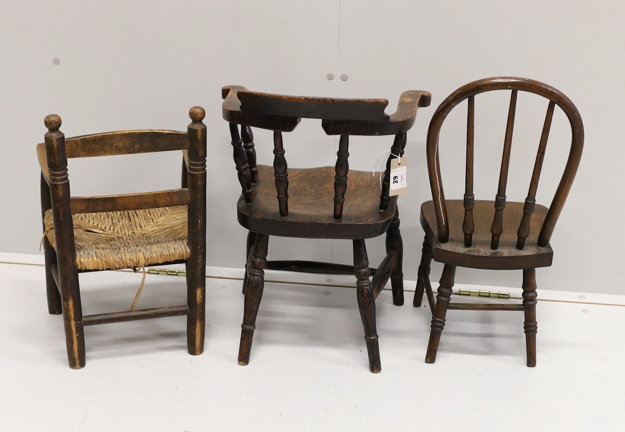 A child's Victorian elm and beech bow chair, a single chair and a rush seat chair